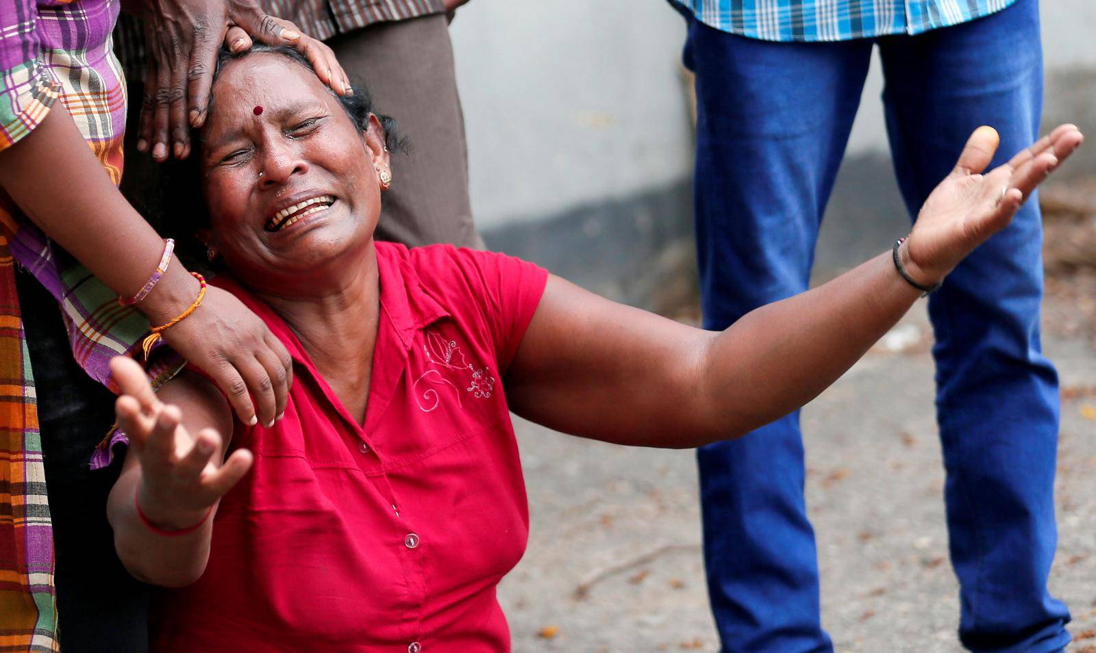 A relative of a victim of the explosion at St. Anthony's Shrine, Kochchikade church, reacts at the police mortuary in Colombo