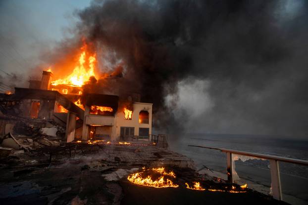 Palisades fire burns during a windstorm on the west side of Los Angeles