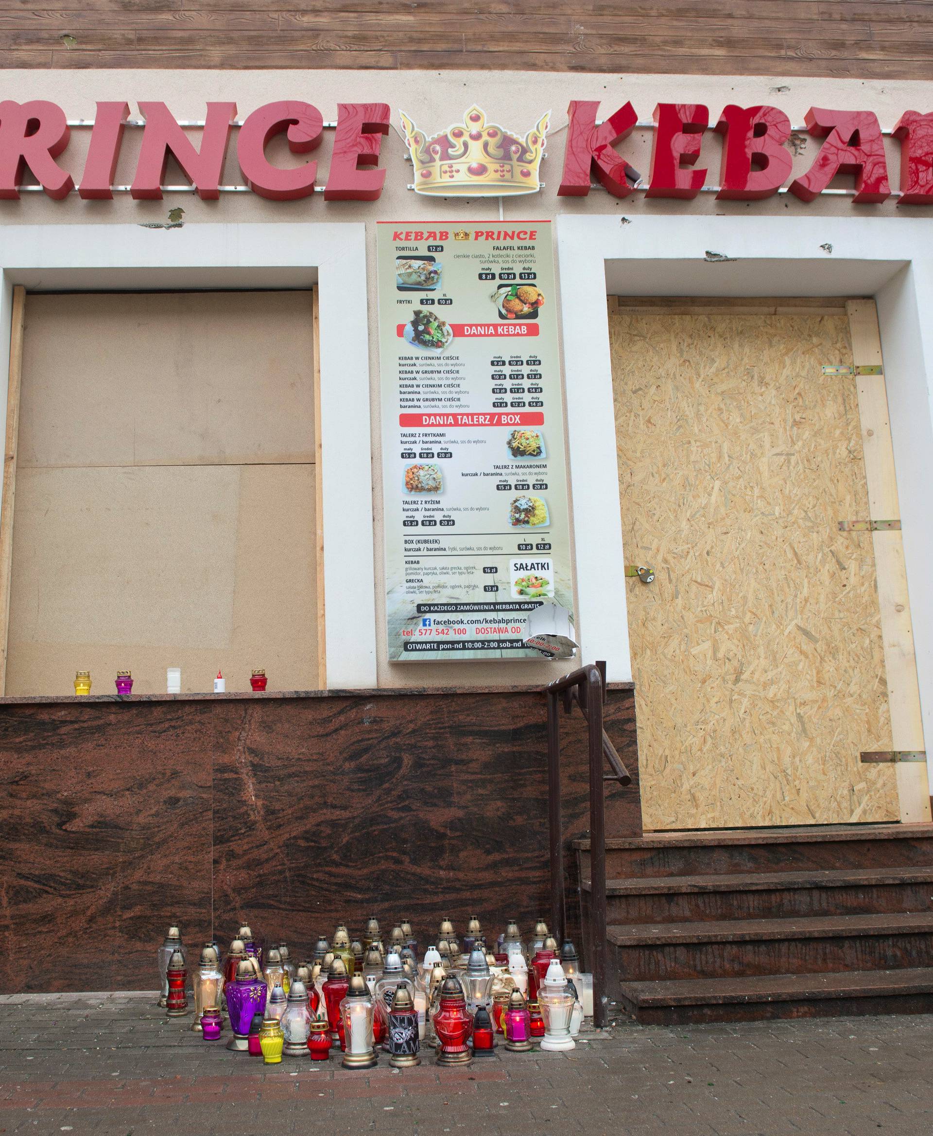 A man stands in front of the kebab shop where a 21-year old man was stabbed to death during new year's eve in a brawl with shop workers, in Elk