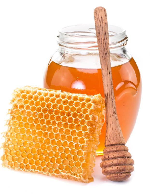 Jar full of fresh honey and honeycombs.