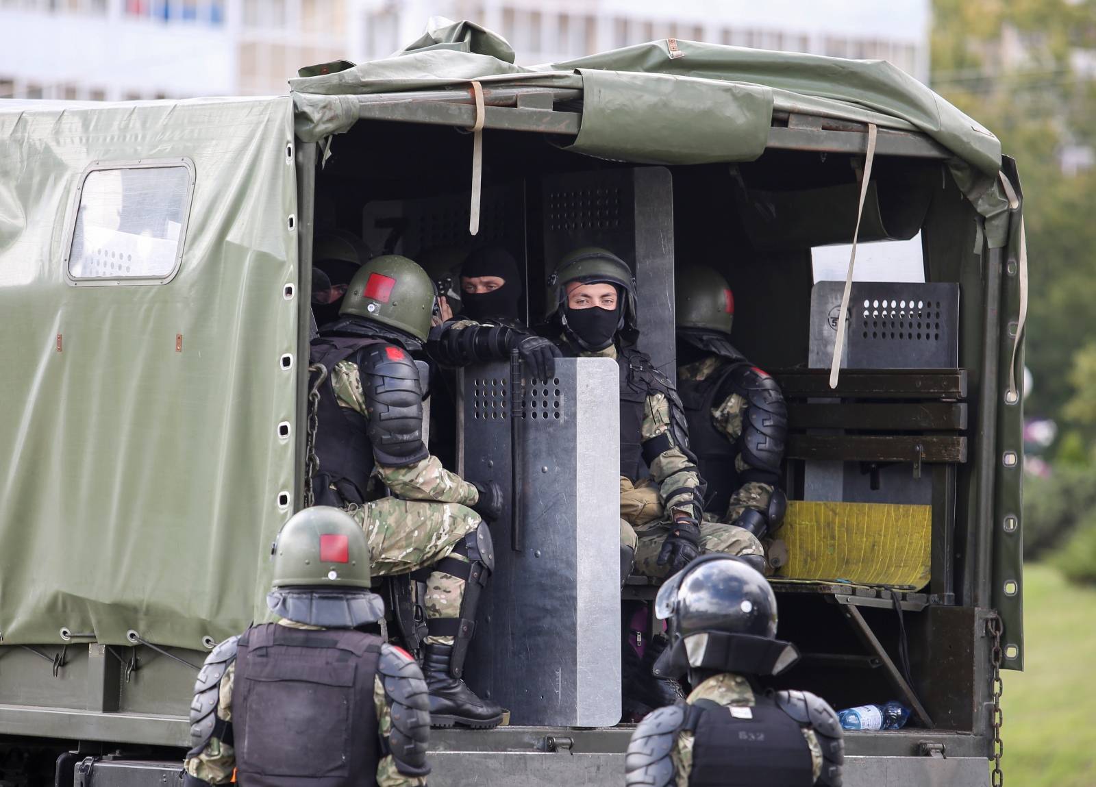 Law enforcement officers sit in a truck during a rally against police brutality following protests to reject the presidential election results in Minsk