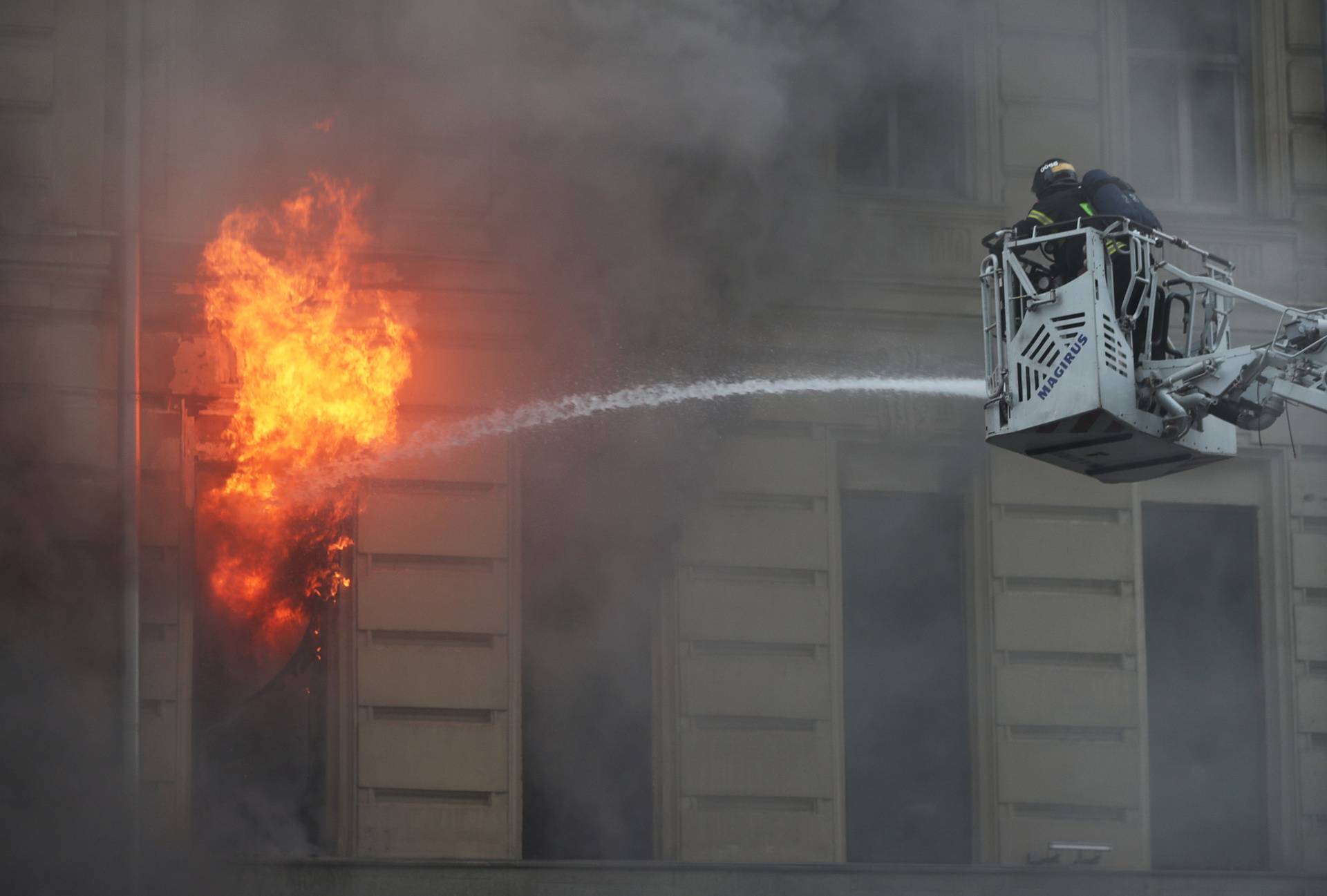 Firefighters work to extinguish a fire at a building in central Moscow