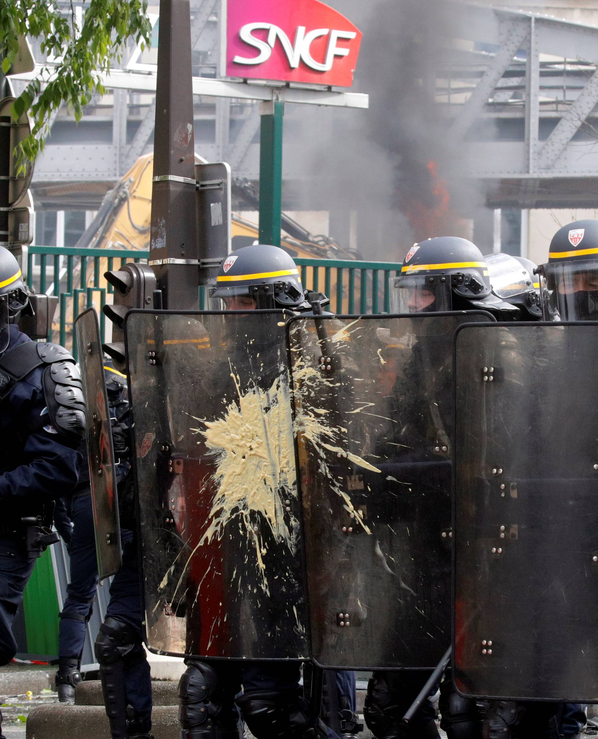 French CRS riot police take position during clashes at the May Day labour union march in Paris