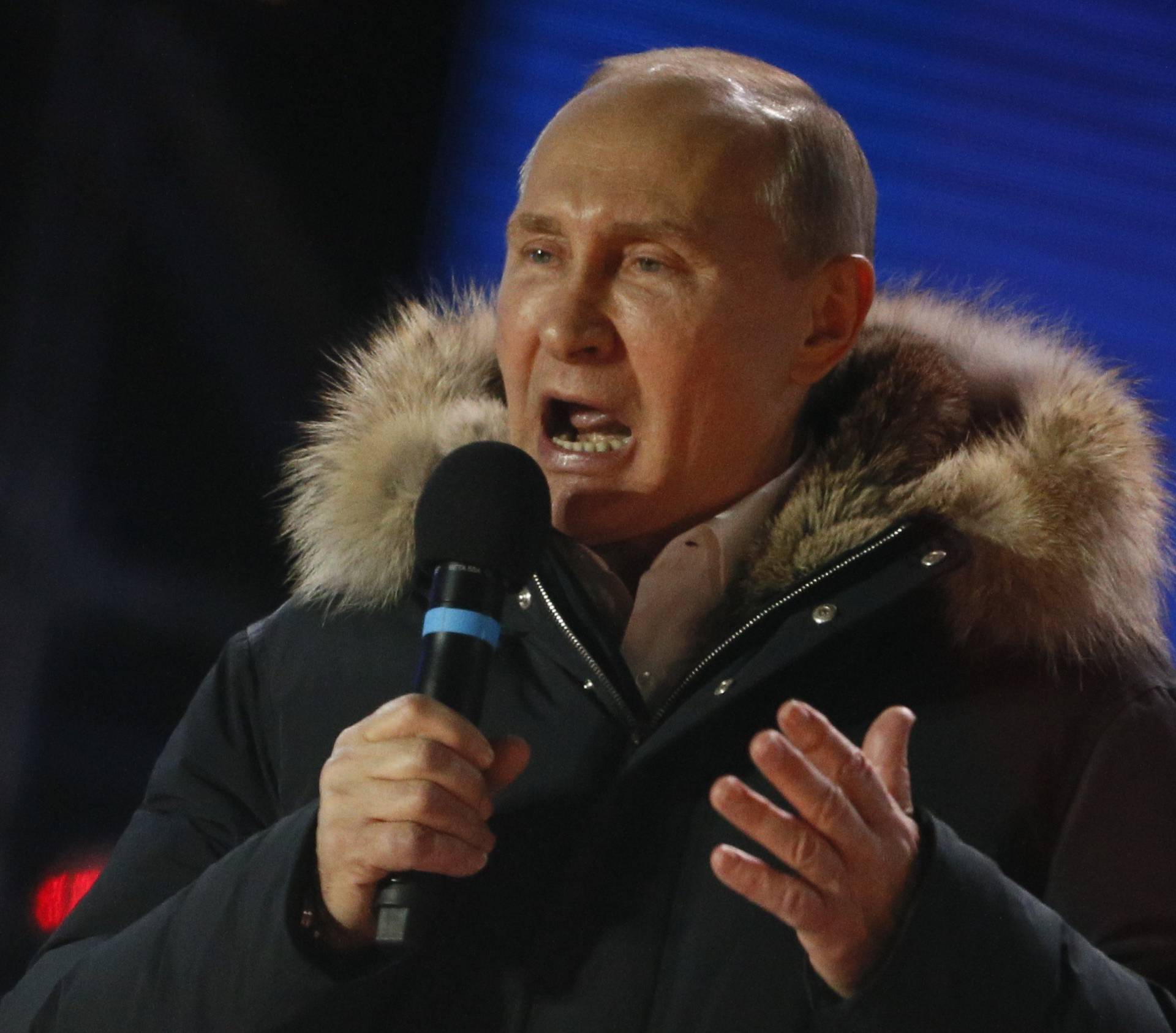 Russian President and Presidential candidate Putin delivers a speech during a rally and concert marking the fourth anniversary of Russia's annexation of the Crimea region, in central Moscow