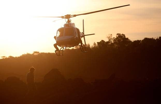 A rescue helicopter flies after a tailings dam owned by Brazilian mining company Vale SA collapsed, in Brumadinho