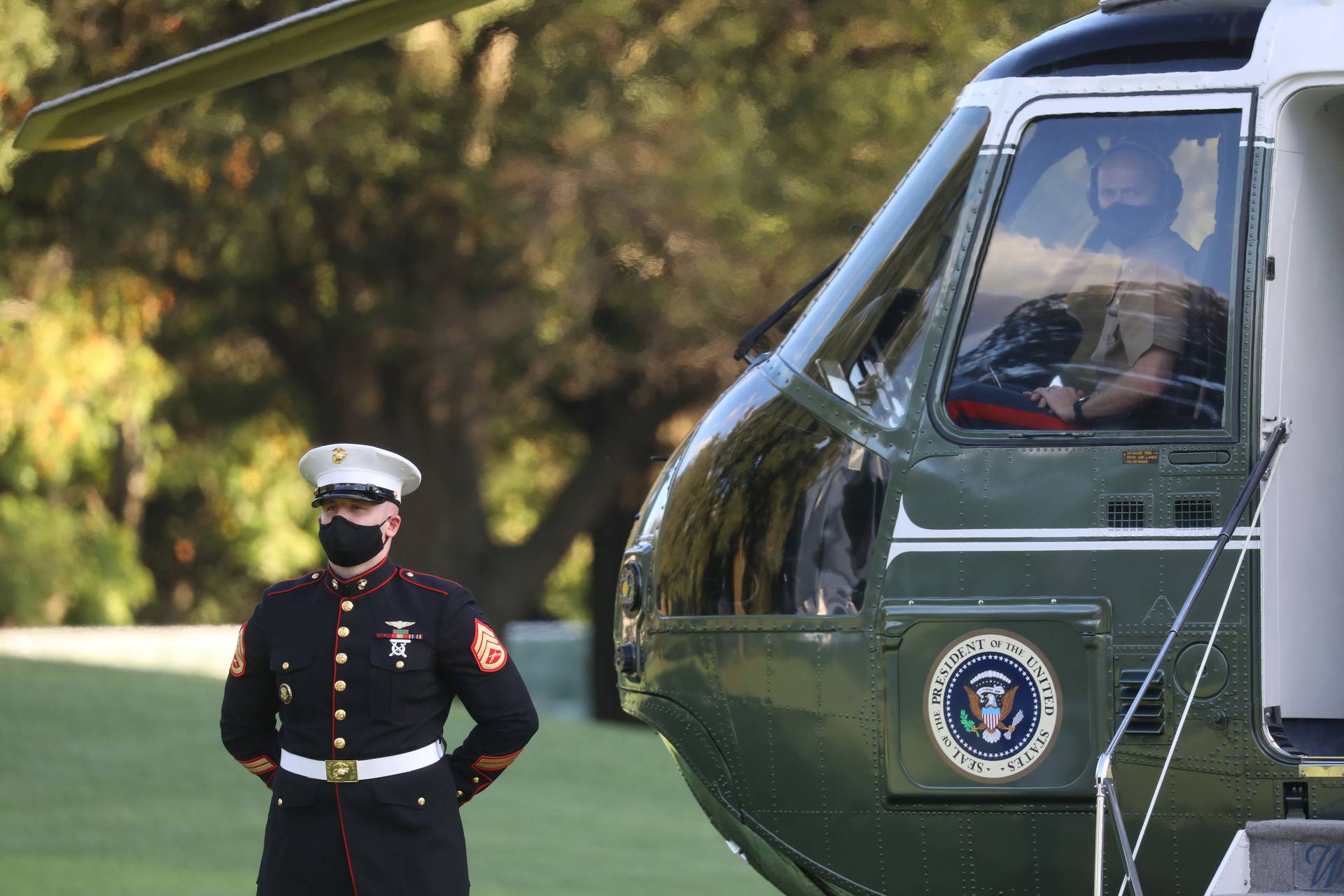 U.S. Marine waits by Marine One for U.S. President Trump to depart for Walter Reed Medical Center from the White House in Washington