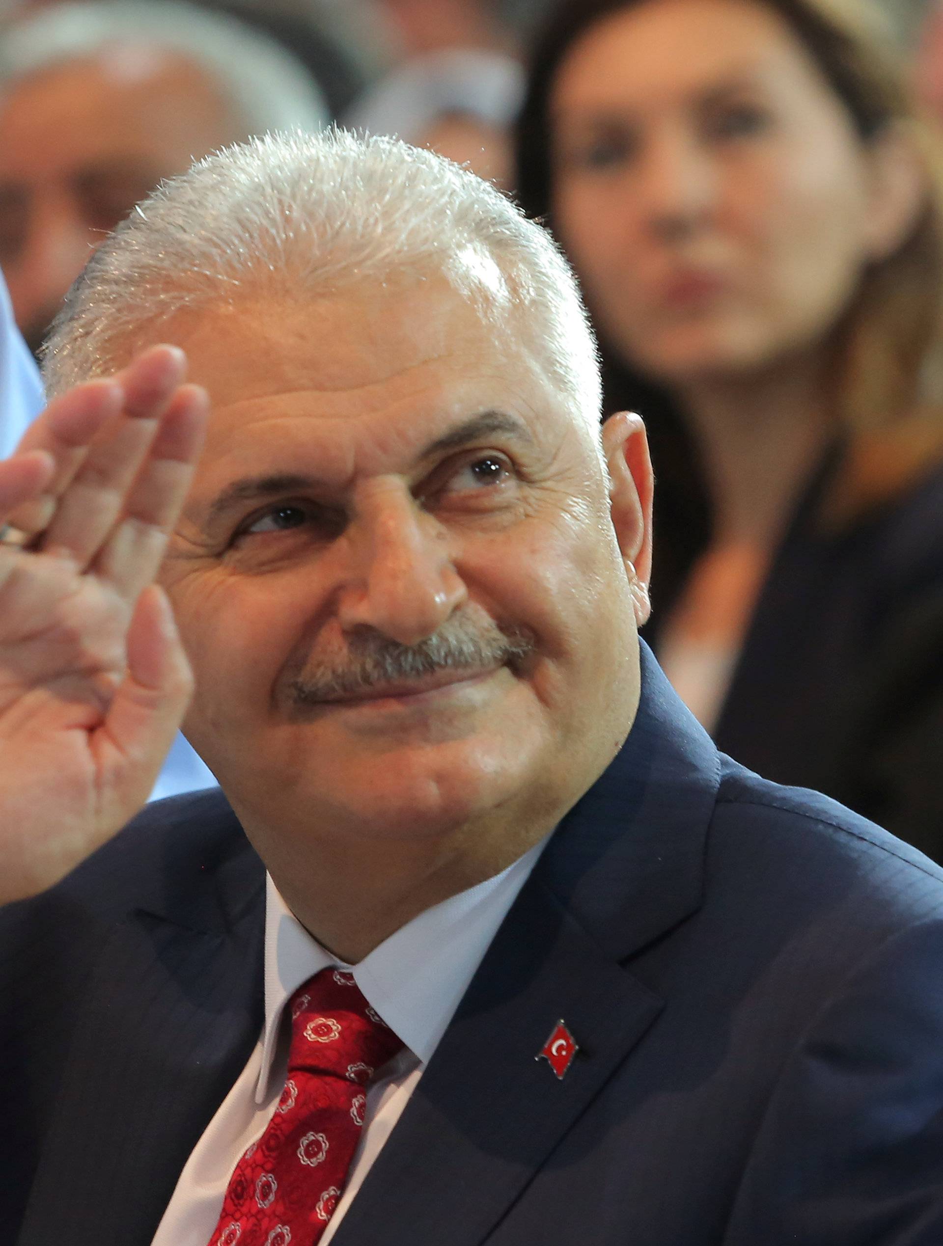 Turkey's Transportation Minister Yildirim greets members of his party during the AKP extraordinary congress in Ankara