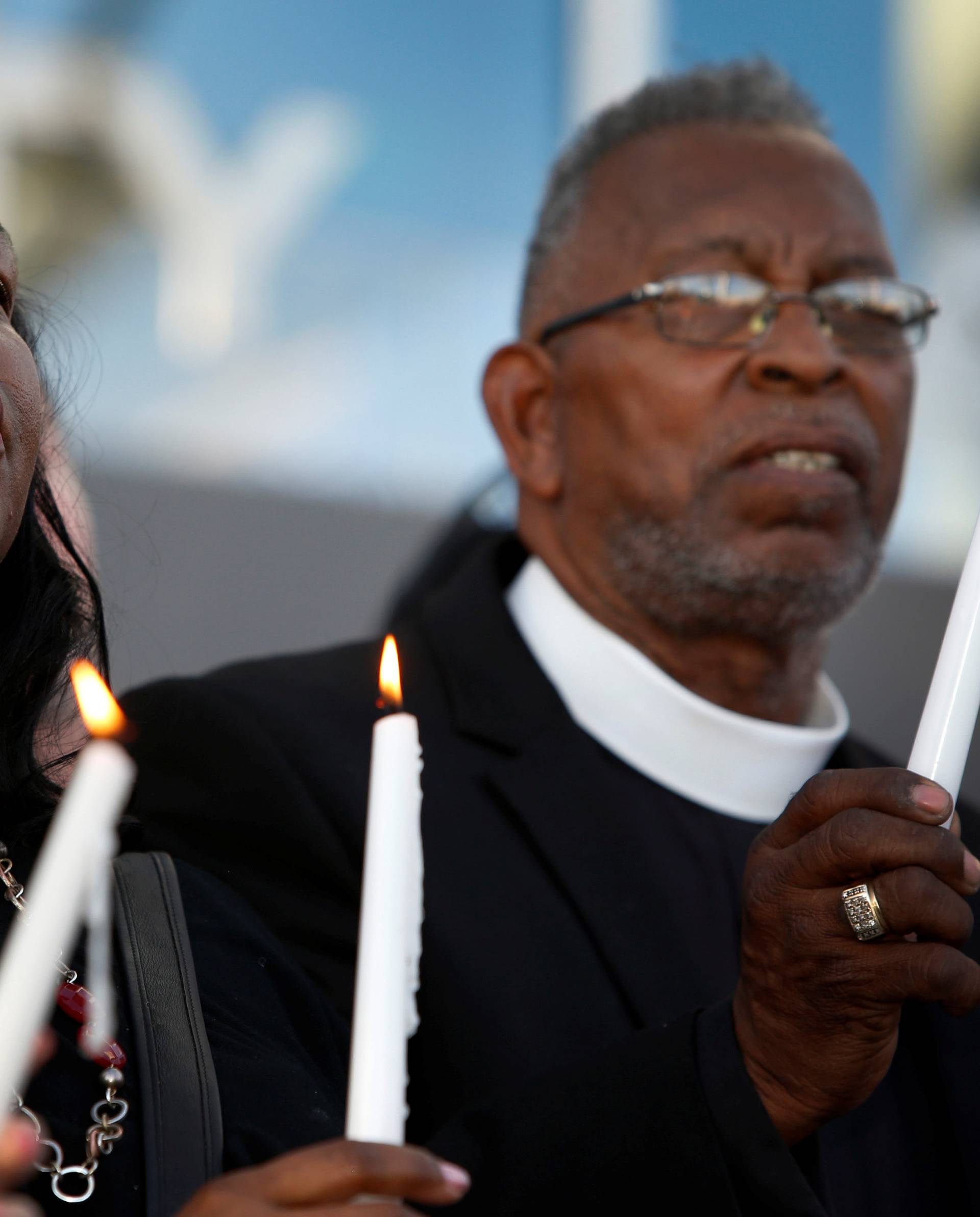 Tyler and Pastor McCurdy hold candles during a prayer vigil in honor of those affected by the shooting in Las Vegas
