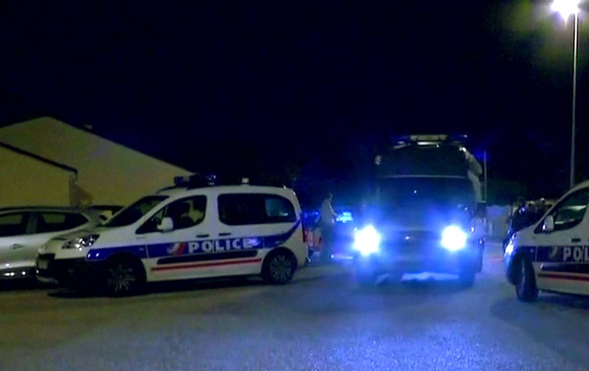Police vehicles at the scene where a French police commander was stabbed to death in front of his home in the Paris suburb of Magnanville