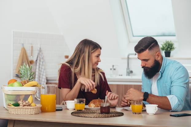 Couple having breakfast at home