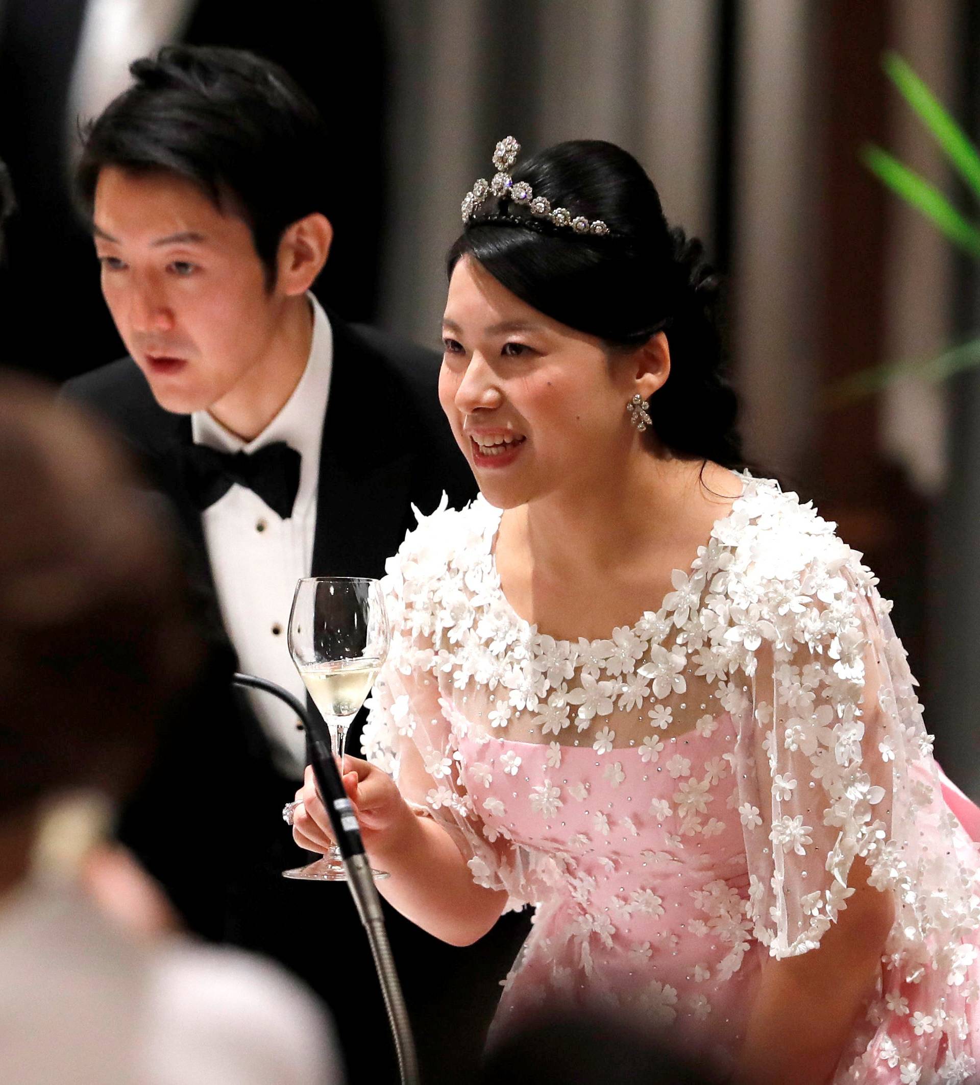 Japan's former princess Ayako Moriya and her husband Kei Moriya toast with Crown Prince Naruhito at their wedding banquet in Tokyo