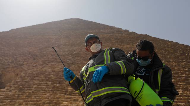 Members of the medical team prepare to spray disinfectant as a precautionary move amid concerns over the coronavirus disease (COVID-19) outbreak at the Great Pyramids, Giza, on the outskirts of Cairo