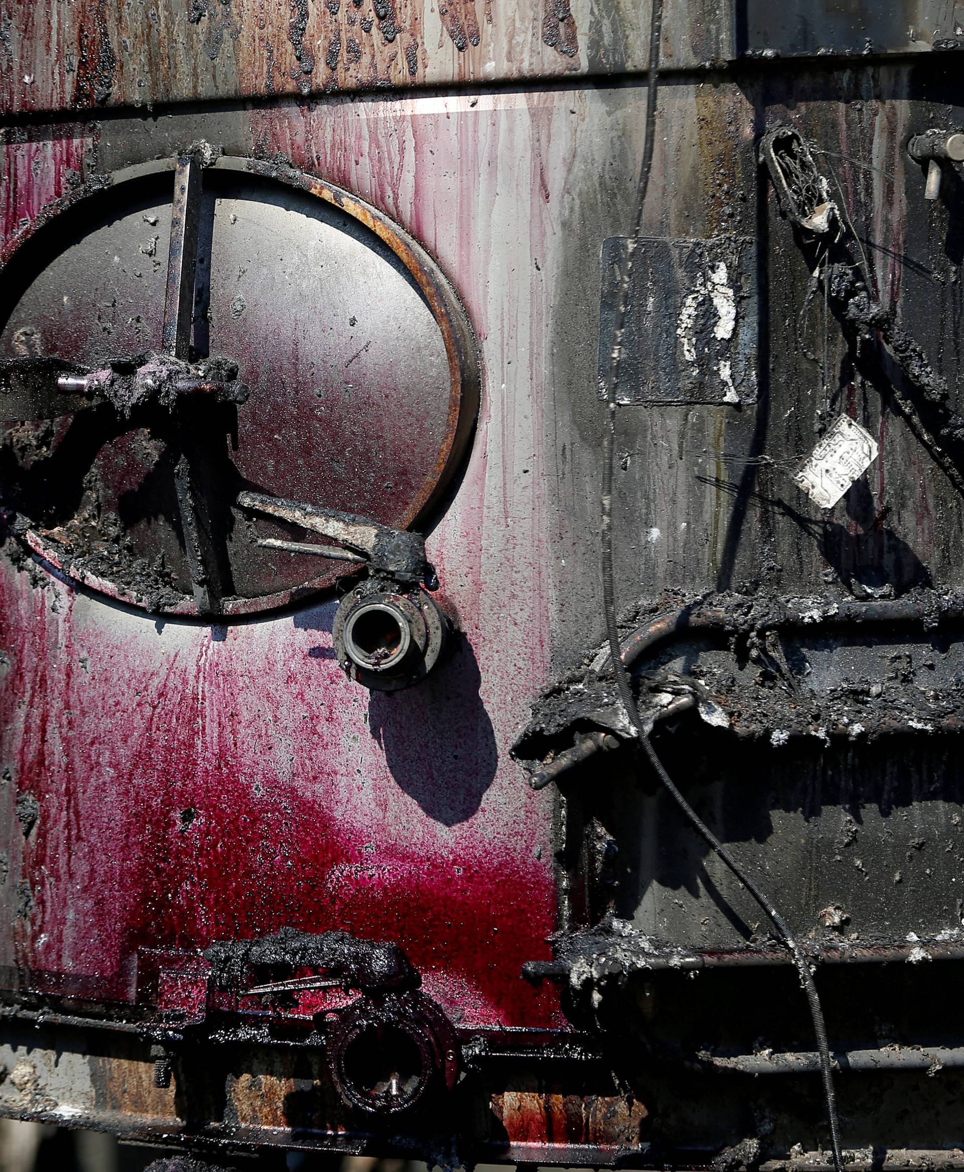 Wine stains are seen on a fermentation tank at Paradise Ridge Winery after being destroyed by the Tubbs Fire in Santa Rosa, California