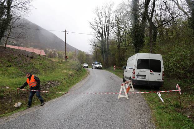 A man closes off the road leading to the site where Ireland's top rally driver Craig Breen was killed in an accident near the village of Stari Golubovec