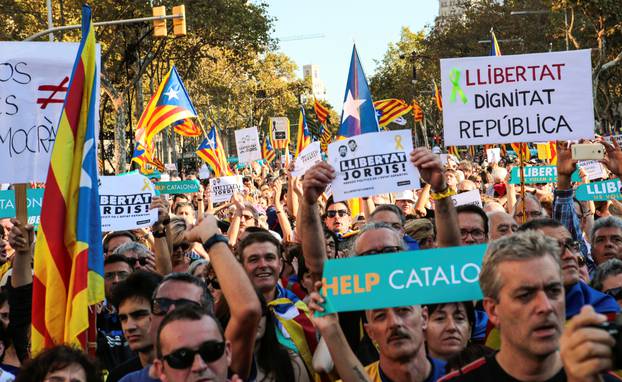 People hold banners and flags during a demonstration organised by Catalan pro-independence movements ANC (Catalan National Assembly) and Omnium Cutural, following the imprisonment of their two leaders, in Barcelona