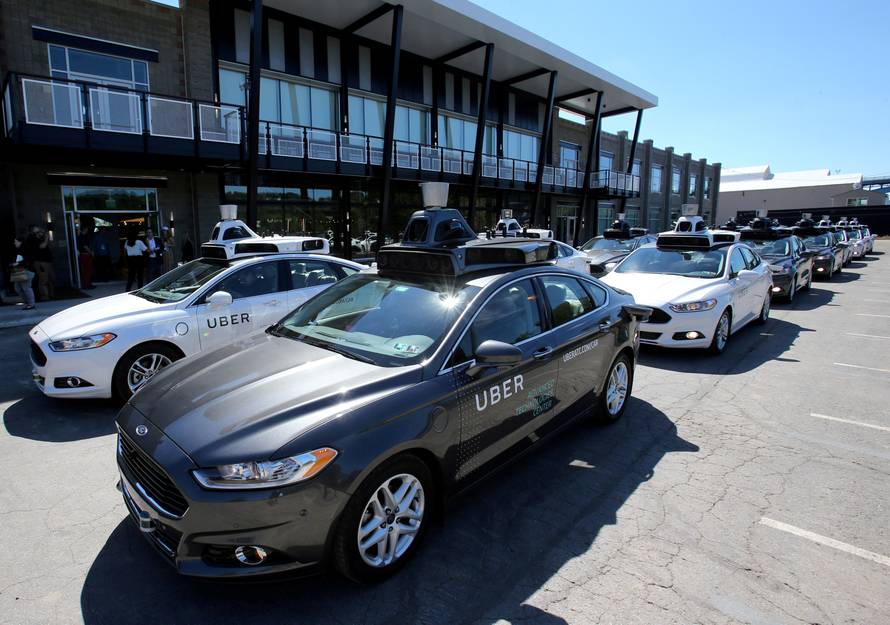 FILE PHOTO: A fleet of Uber's Ford Fusion self driving cars are shown during a demonstration of self-driving automotive technology in Pittsburgh