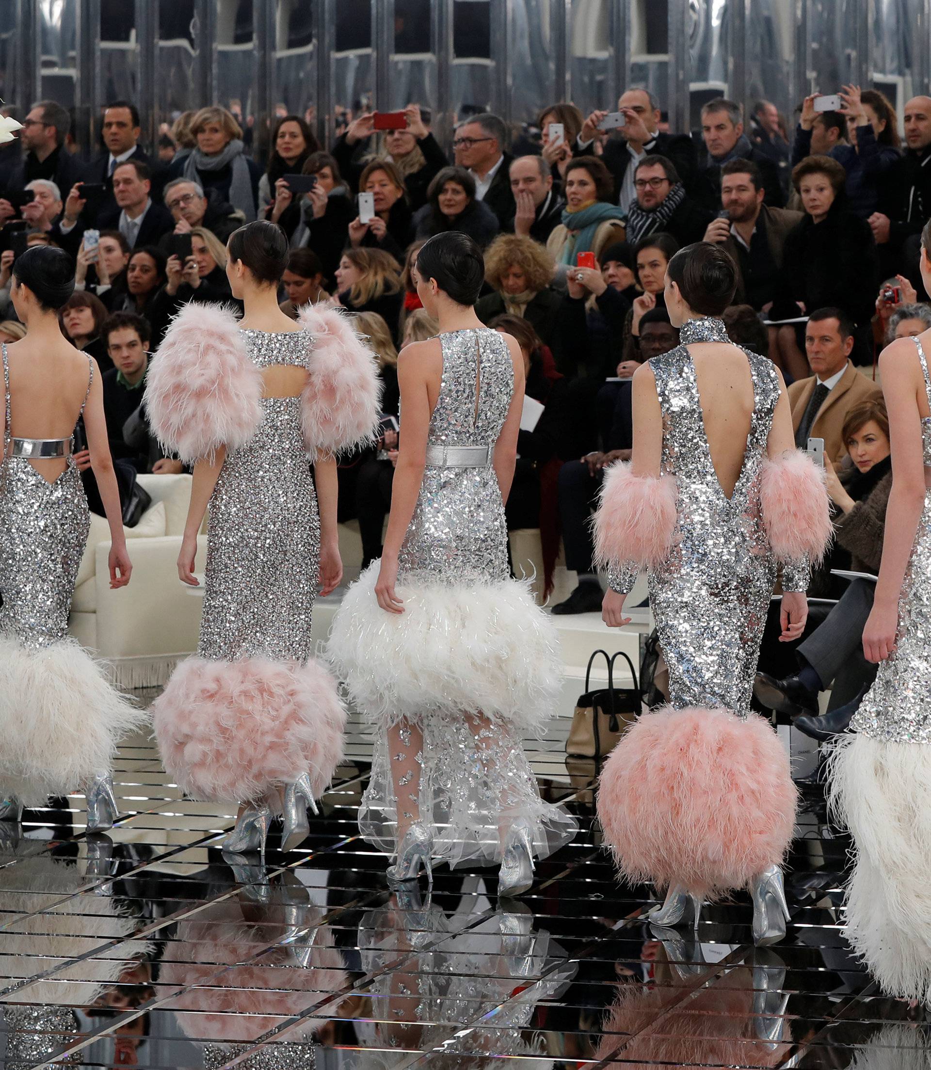 Models present creations by German designer Karl Lagerfeld as part of his Haute Couture Spring/Summer 2017 fashion show for Chanel in Paris