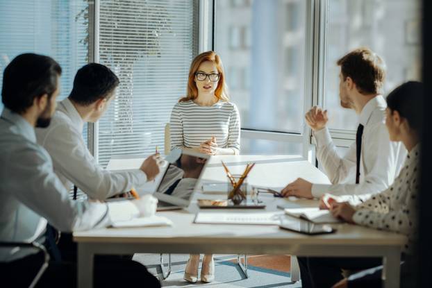 Female boss developing project plan with her employees