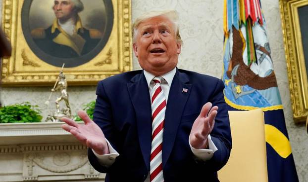 U.S. President Donald Trump answers reporters questions in the Oval Office of the White House In Washington