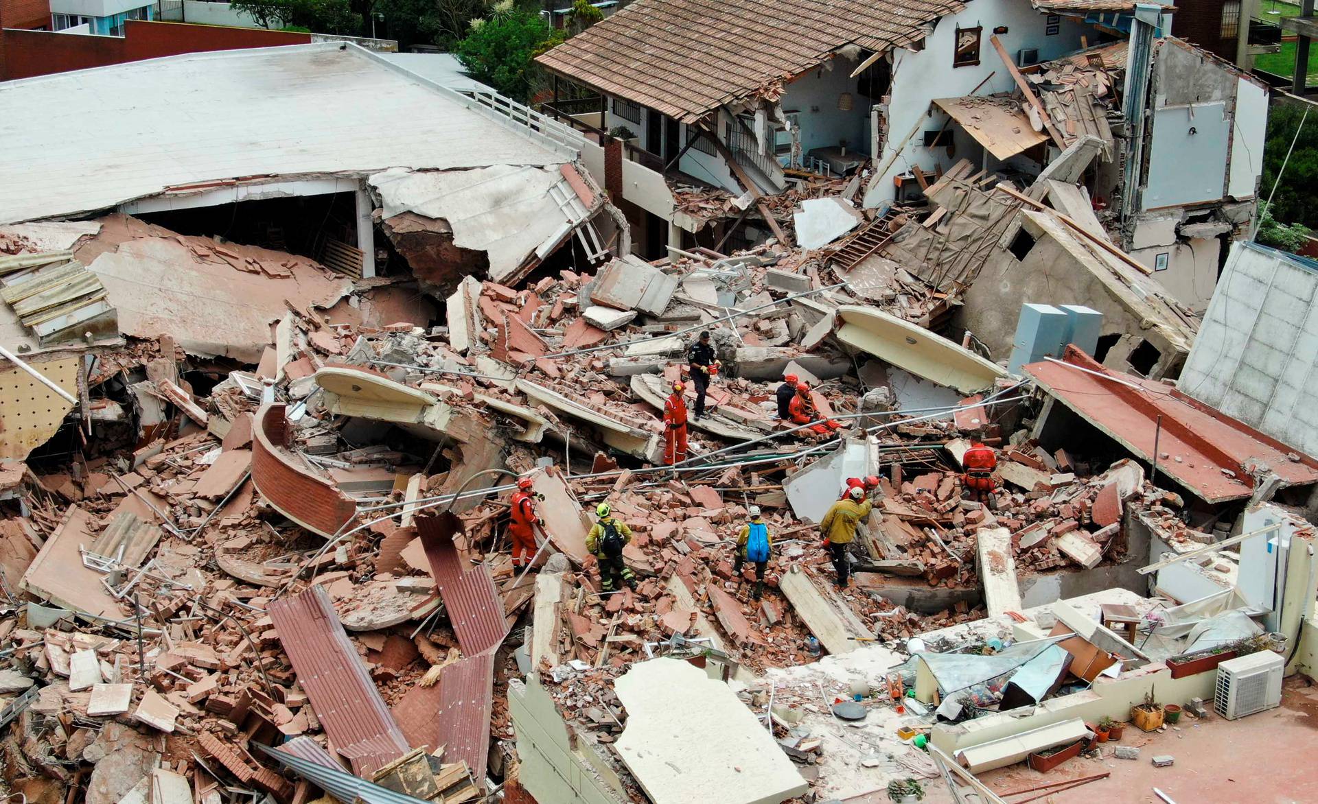 Firefighters search for trapped people after a hotel collapses in Villa Gesell