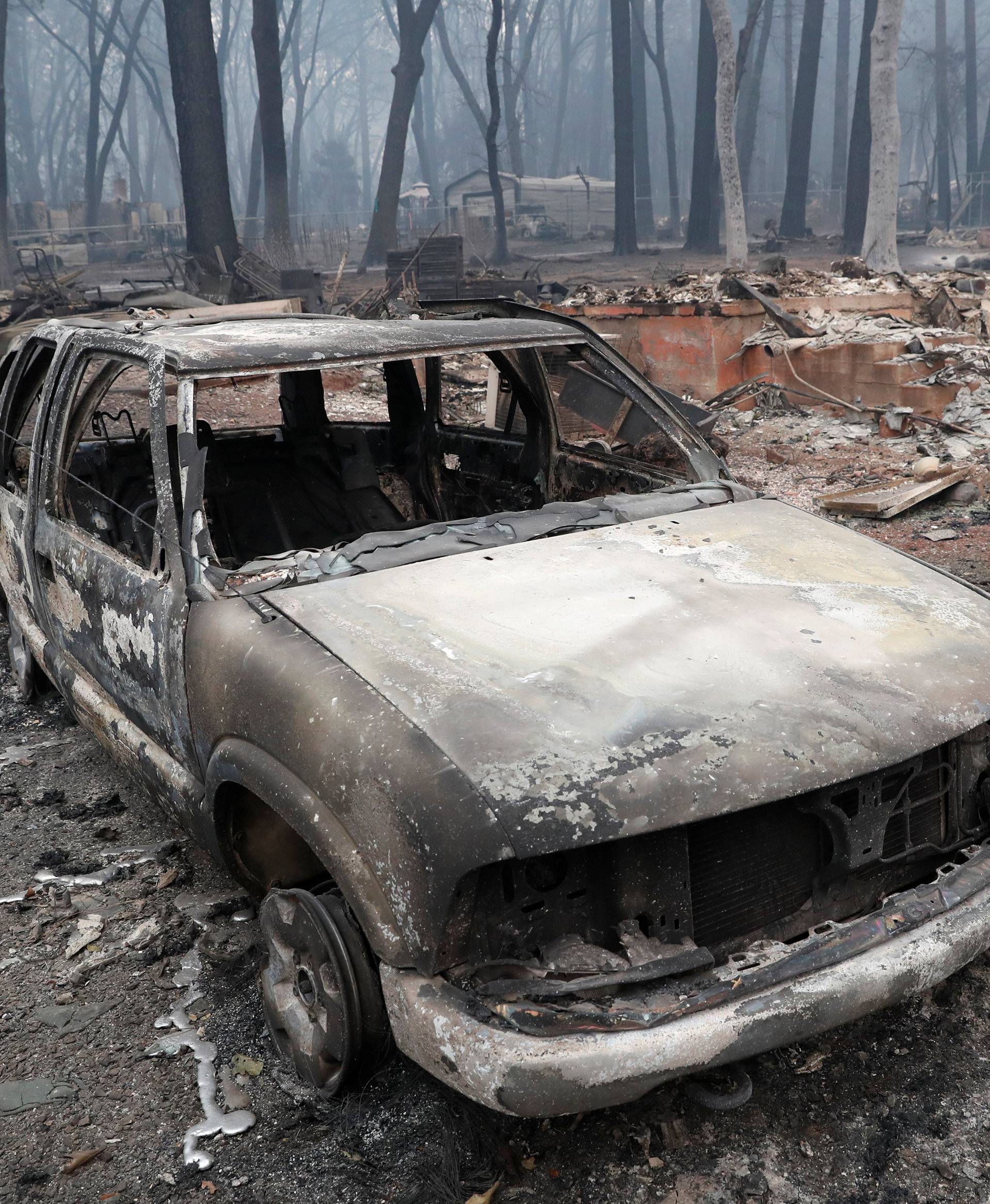 A car destroyed by the Camp Fire is seen in Paradise