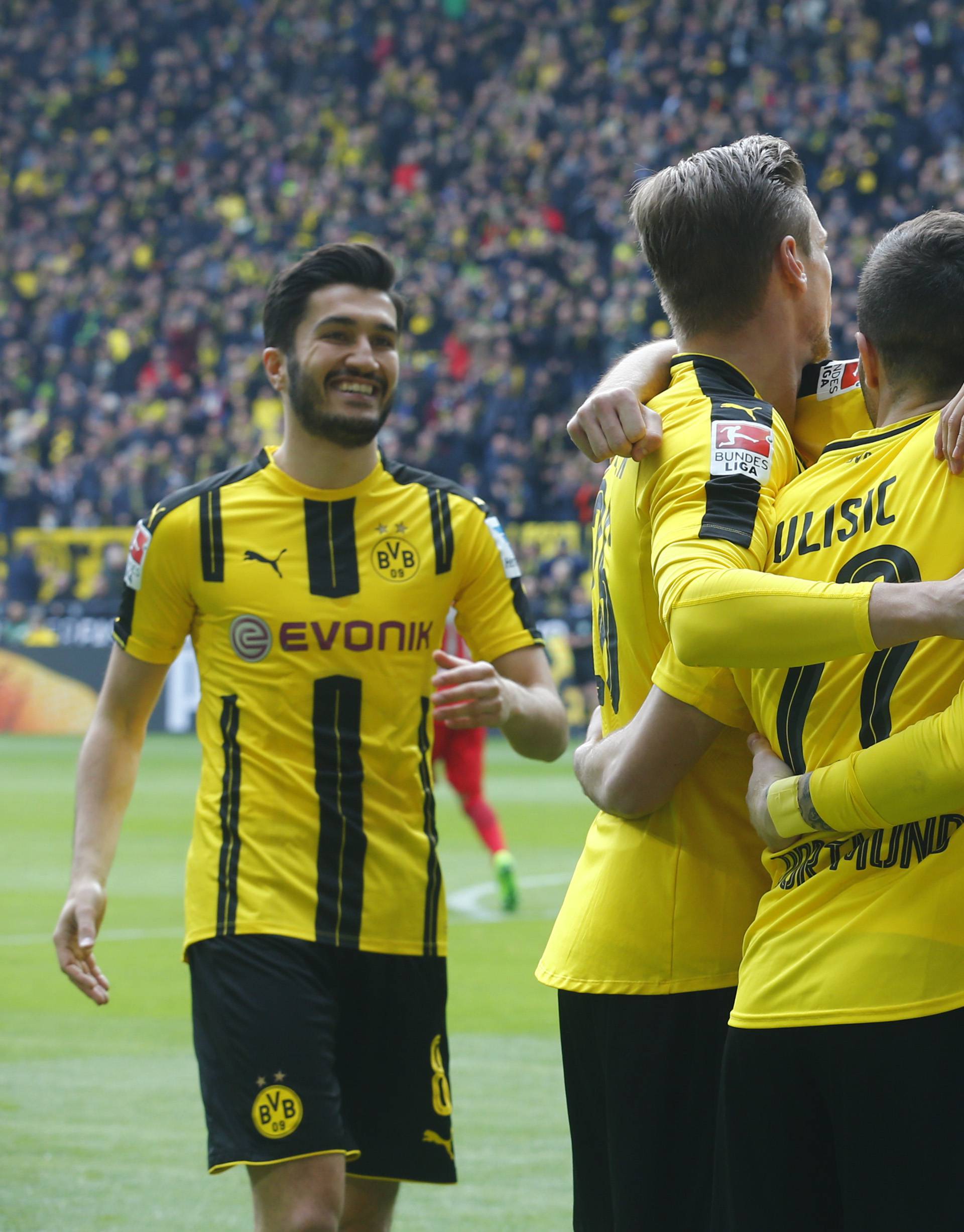 Borussia Dortmund's Marco Reus celebrates scoring their first goal with team mates