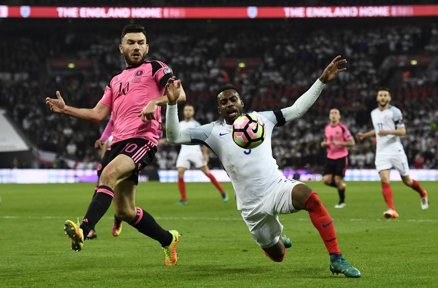 England's Danny Rose goes down in the box under a challenge from Scotland's Robert Snodgrass