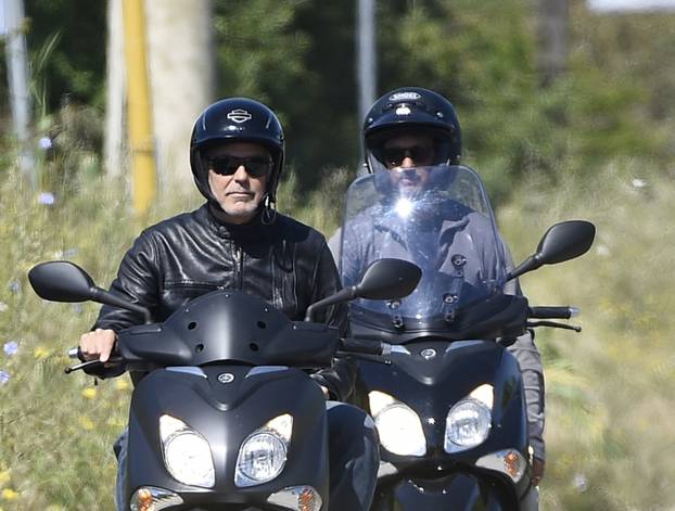 George Clooney riding a scooter in Sardinia