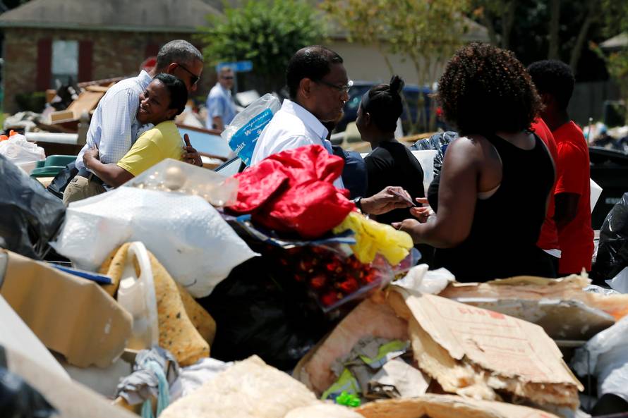U.S. President Barack Obama tours a flood-affected neighborhood in Zachary