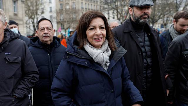 Protesters march in Paris to urge governments to act against climate change and social injustice