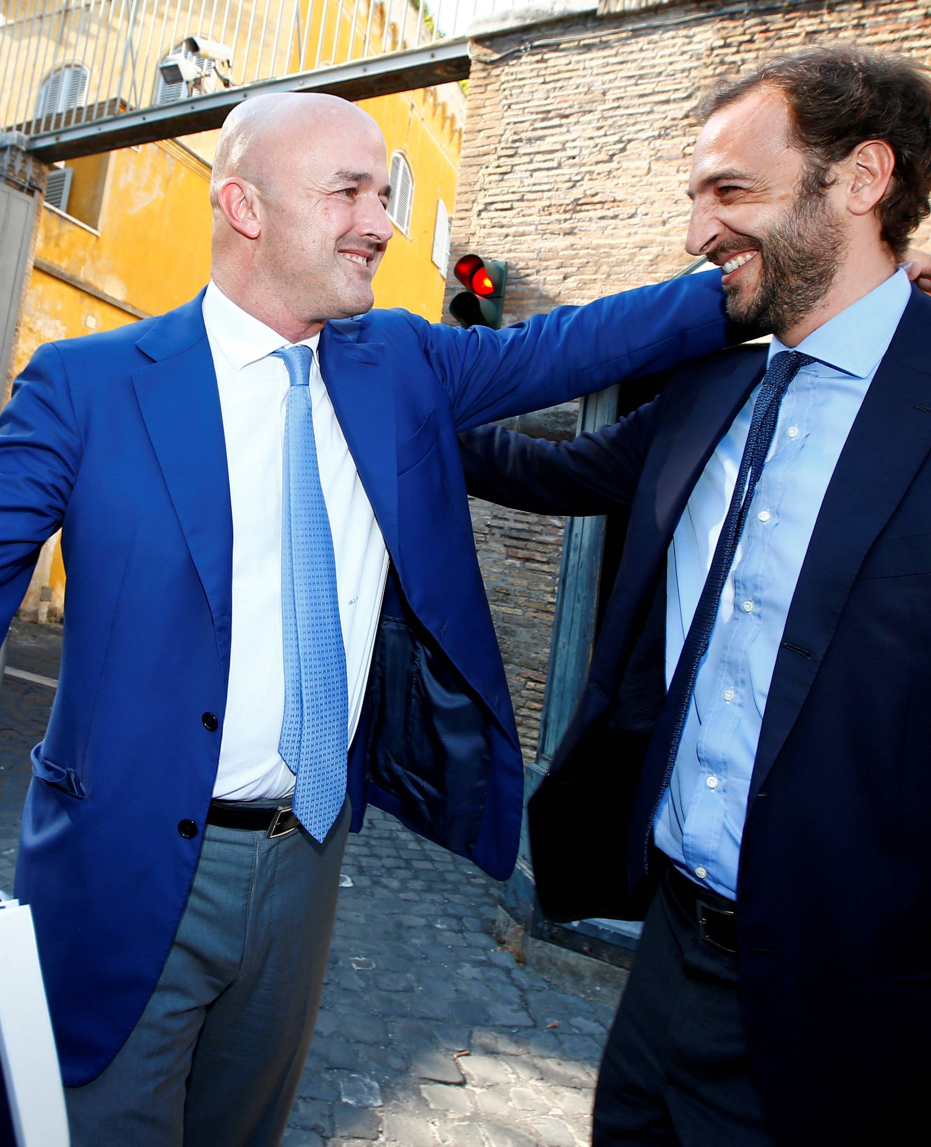 Journalists Fittipaldi and Nuzzi smile as they leave the Vatican at the end of their trial