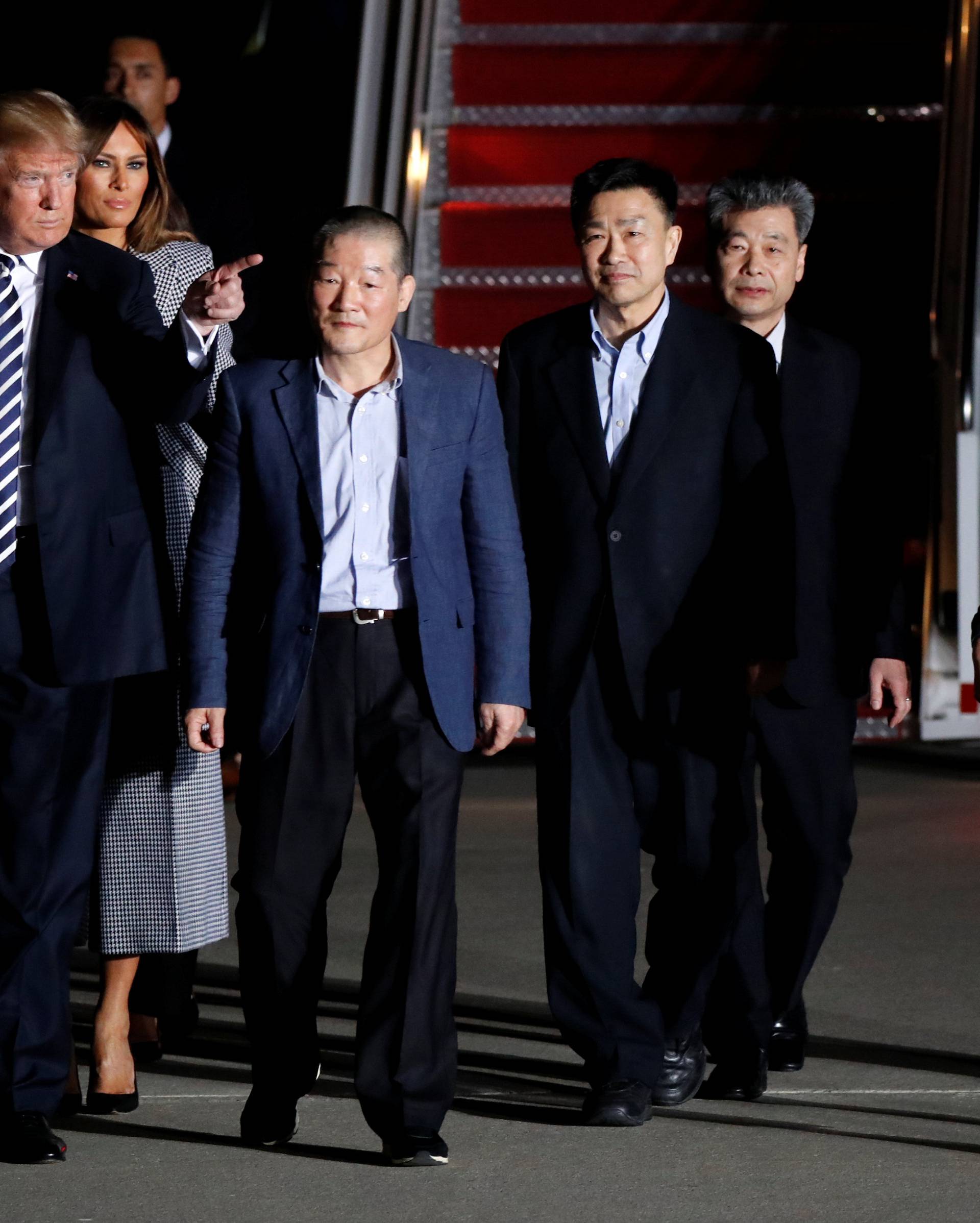 U.S.President Donald Trump gestures next to the three Americans released from detention in North Korea, Tony Kim, Kim Hak-song and Kim Dong-chul, upon their arrival at Joint Base Andrews