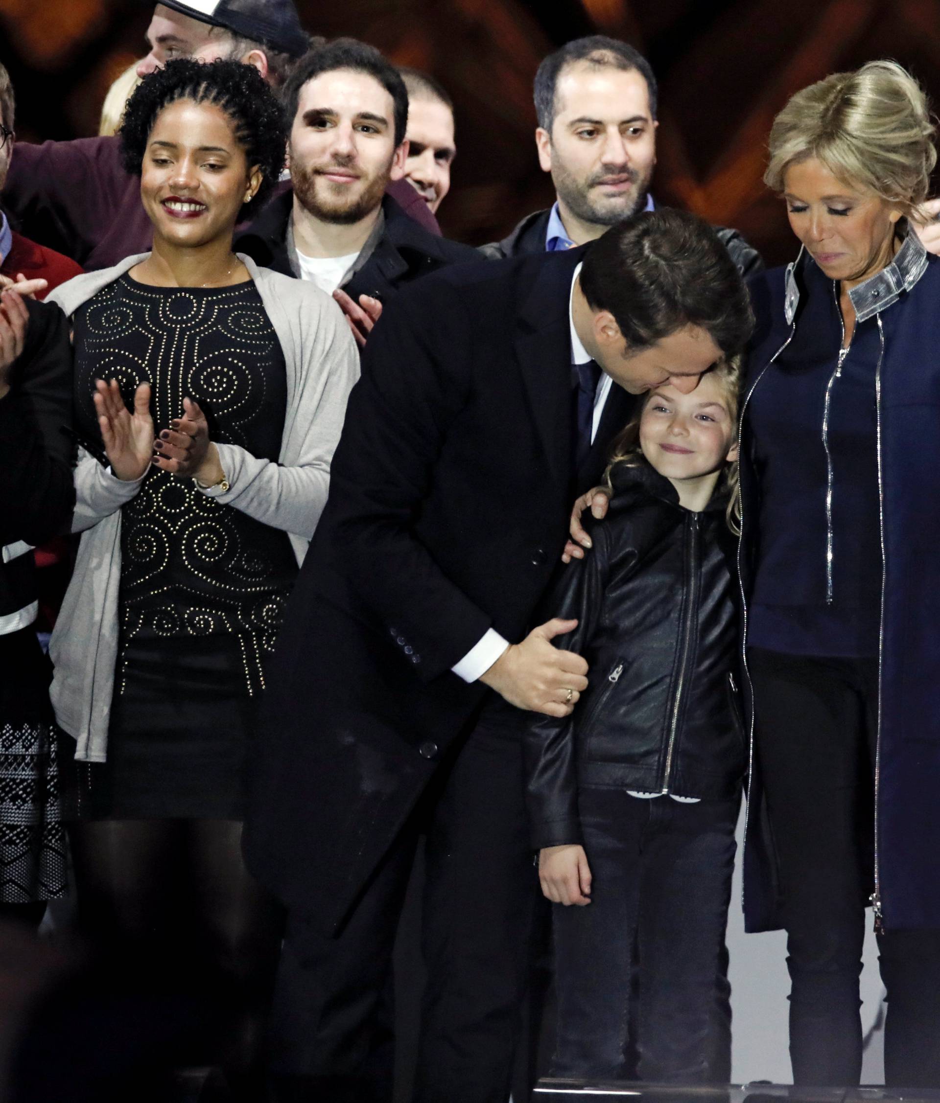 French President elect Emmanuel Macron and his wife Brigitte Trogneux celebrate on the stage at his victory rally near the Louvre in Paris, France May 7, 2017.