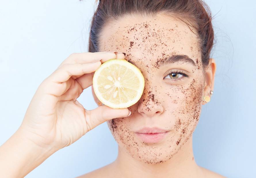 Red-haired woman with a scrub applied to her face