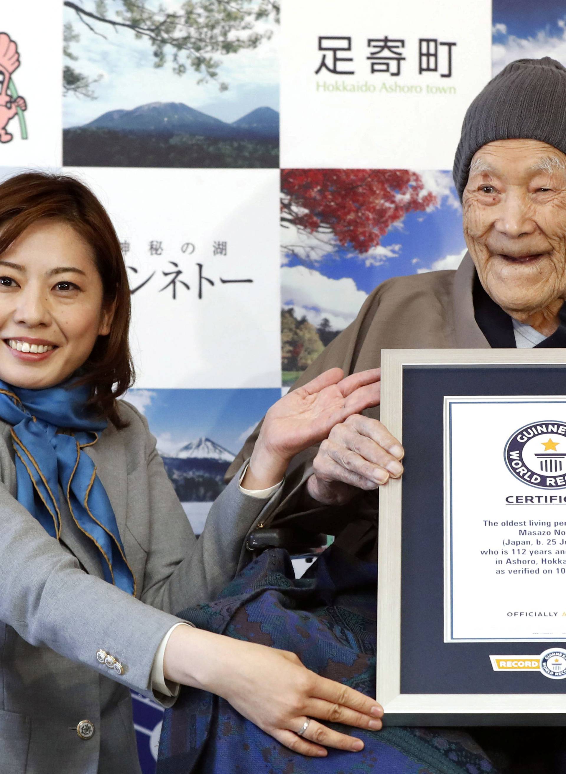 Japanese Masazo Nonaka, who was born 112 years and 259 days ago, receives a Guinness World Records certificate naming him the world's oldest man during a ceremony in Ashoro