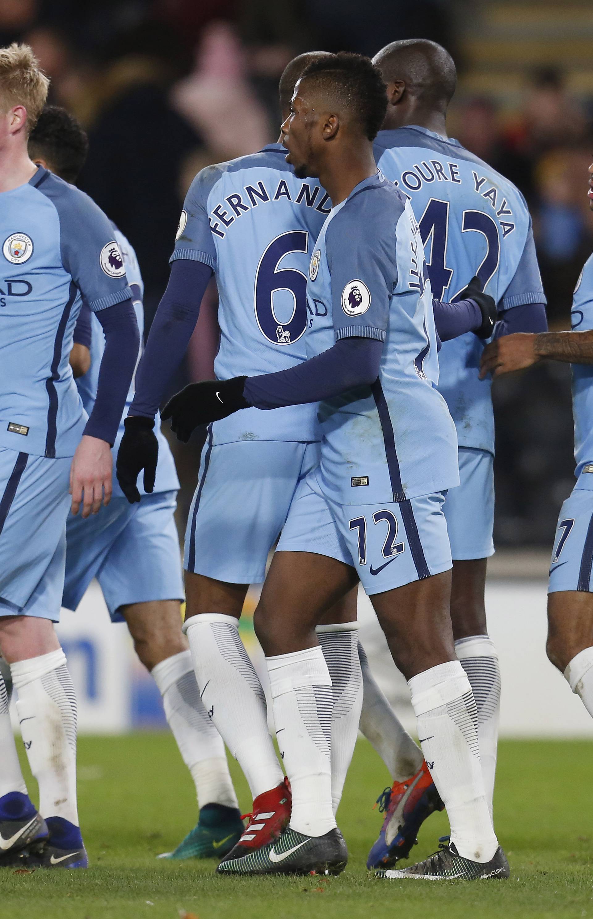 Manchester City's Raheem Sterling celebrate with team mates after Hull City's Curtis Davies scored an own goal and their third goal