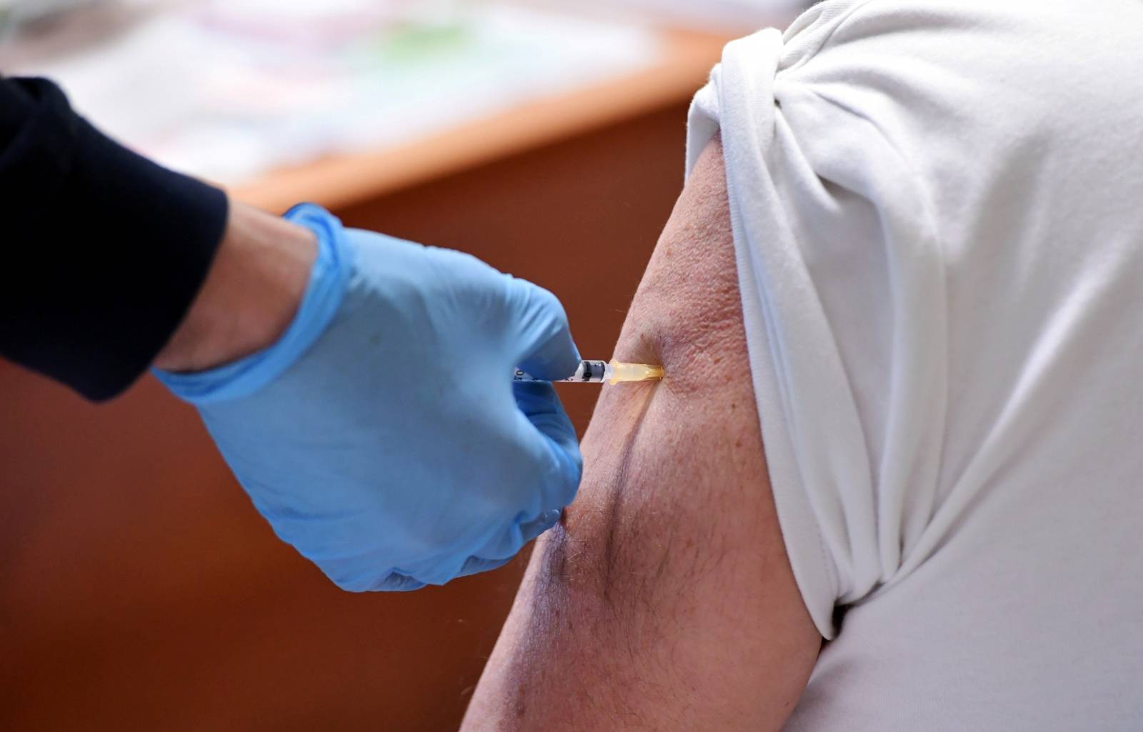 People receive a dose of the Moderna coronavirus disease (COVID-19) vaccine at the Misericordia hospital in Grosseto