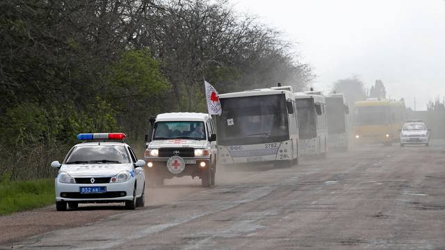 A convoy carrying evacuees from Mariupol area is seen on a road in the Donetsk Region
