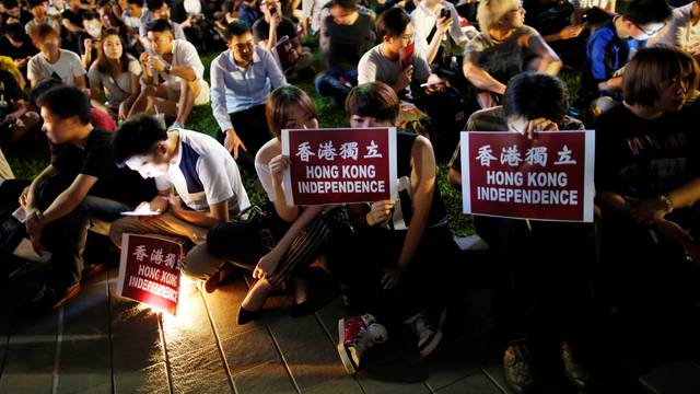 Protesters hold placards during a rally in support of independence advocates who have been barred from the Legislative Council elections in Hong Kong
