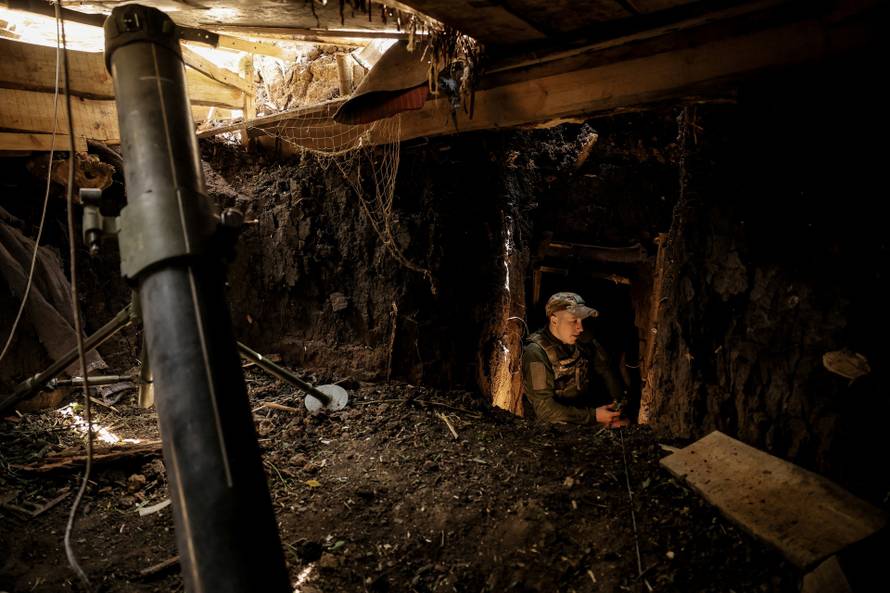Ukrainian servicemen fire a 120-mm mortar towards Russian troops at a frontline near the town of Chasiv Yar