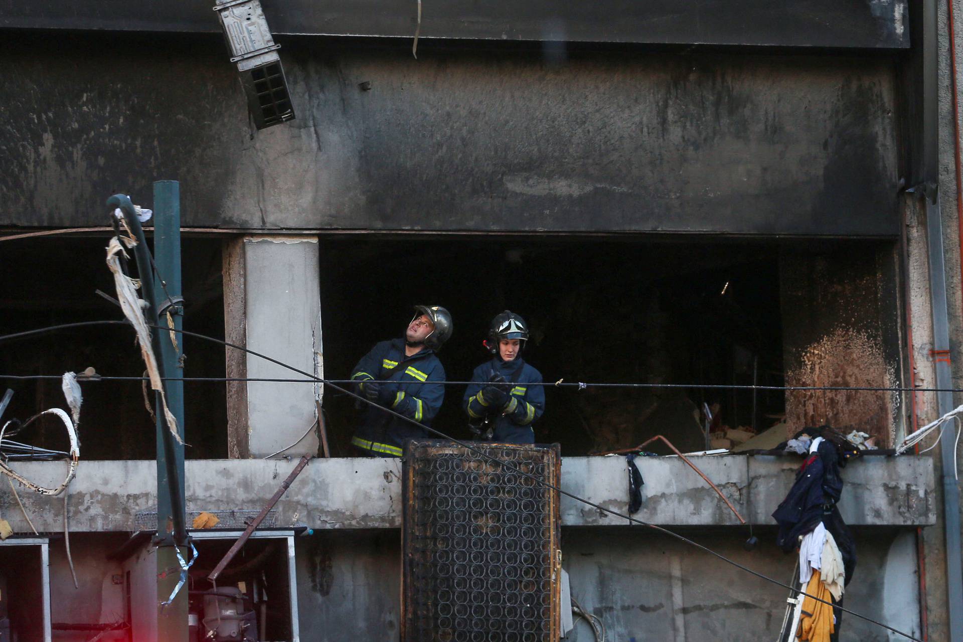 Firefighters are seen inside a building after a blast in Athens