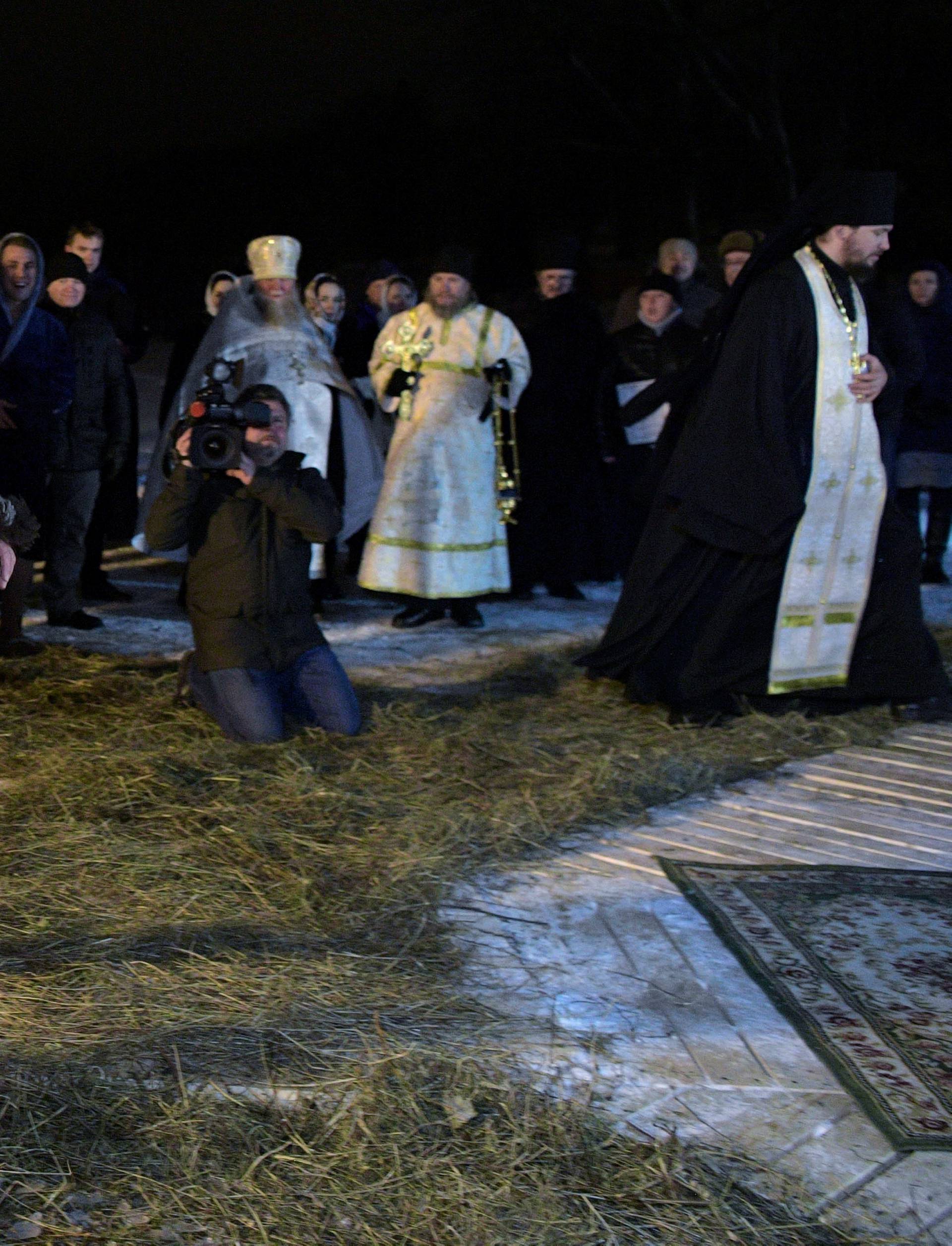 Russian President Vladimir Putin walks to take a dip in the water during Orthodox Epiphany celebrations at lake Seliger, Tver region