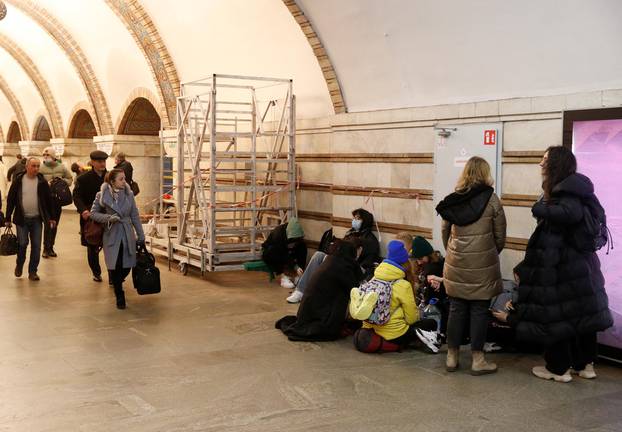 People take shelter in a subway station, after Russian President Vladimir Putin authorized a military operation in eastern Ukraine, in Kyiv