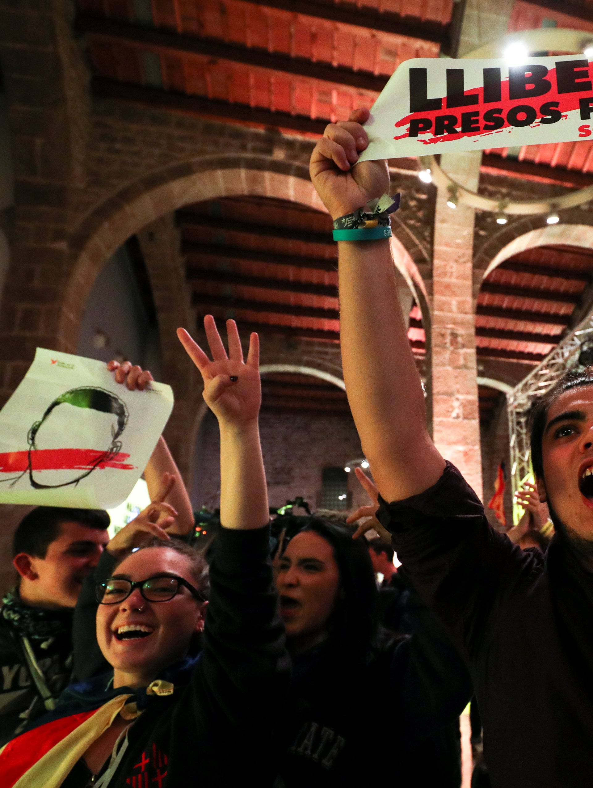 A man holds up a banner at gathering of the Catalan National Assembly (ANC) to follow results in Catalonia's regional elections in Barcelona