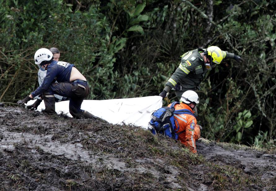 Rescue workers carry the body of a victim from a plane that crashed into the Colombian jungle with Brazilian soccer team Chapecoense onboard, near Medellin