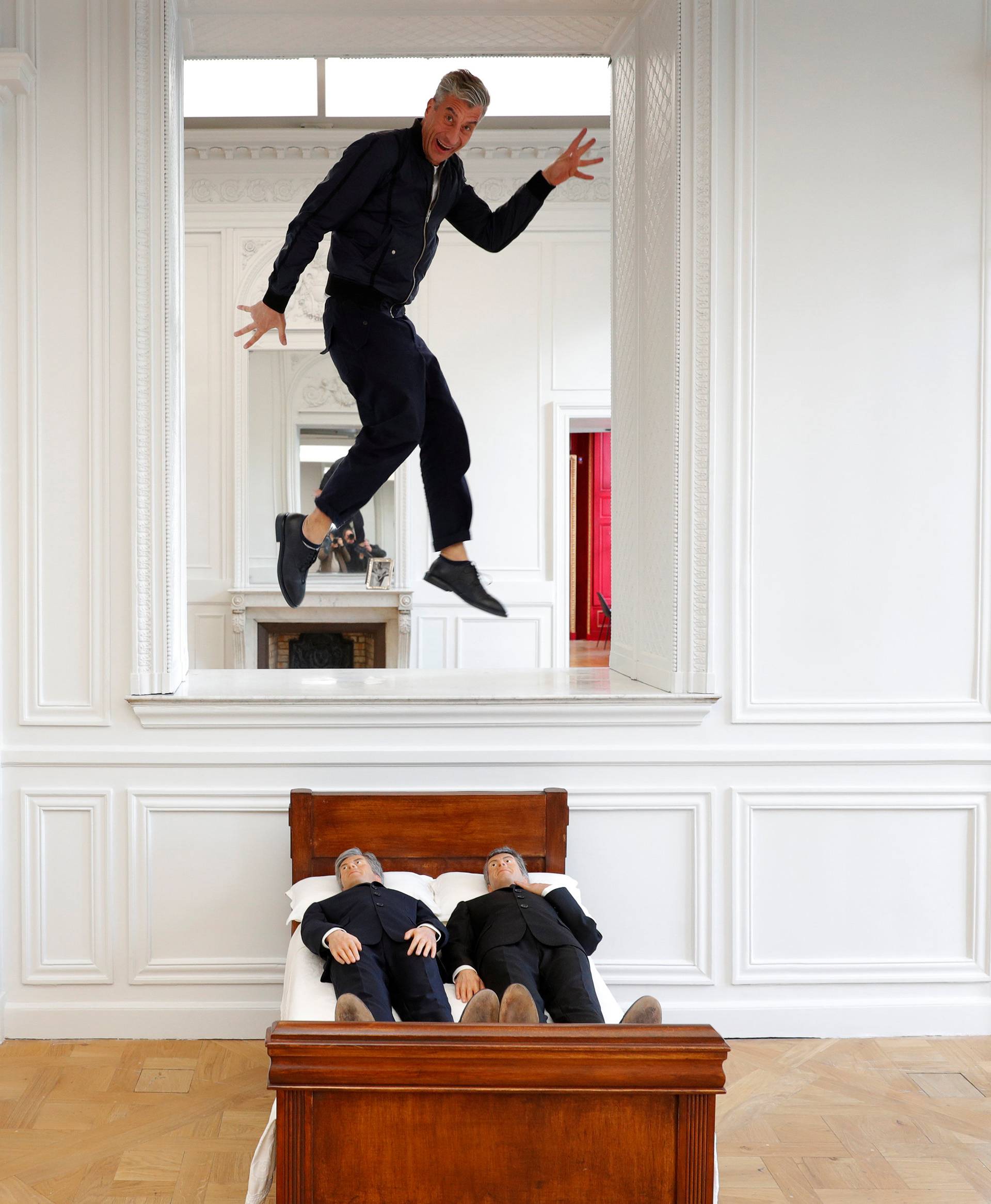 Italian artist Maurizio Cattelan poses with his creation "Is There Life Before Death" in Paris
