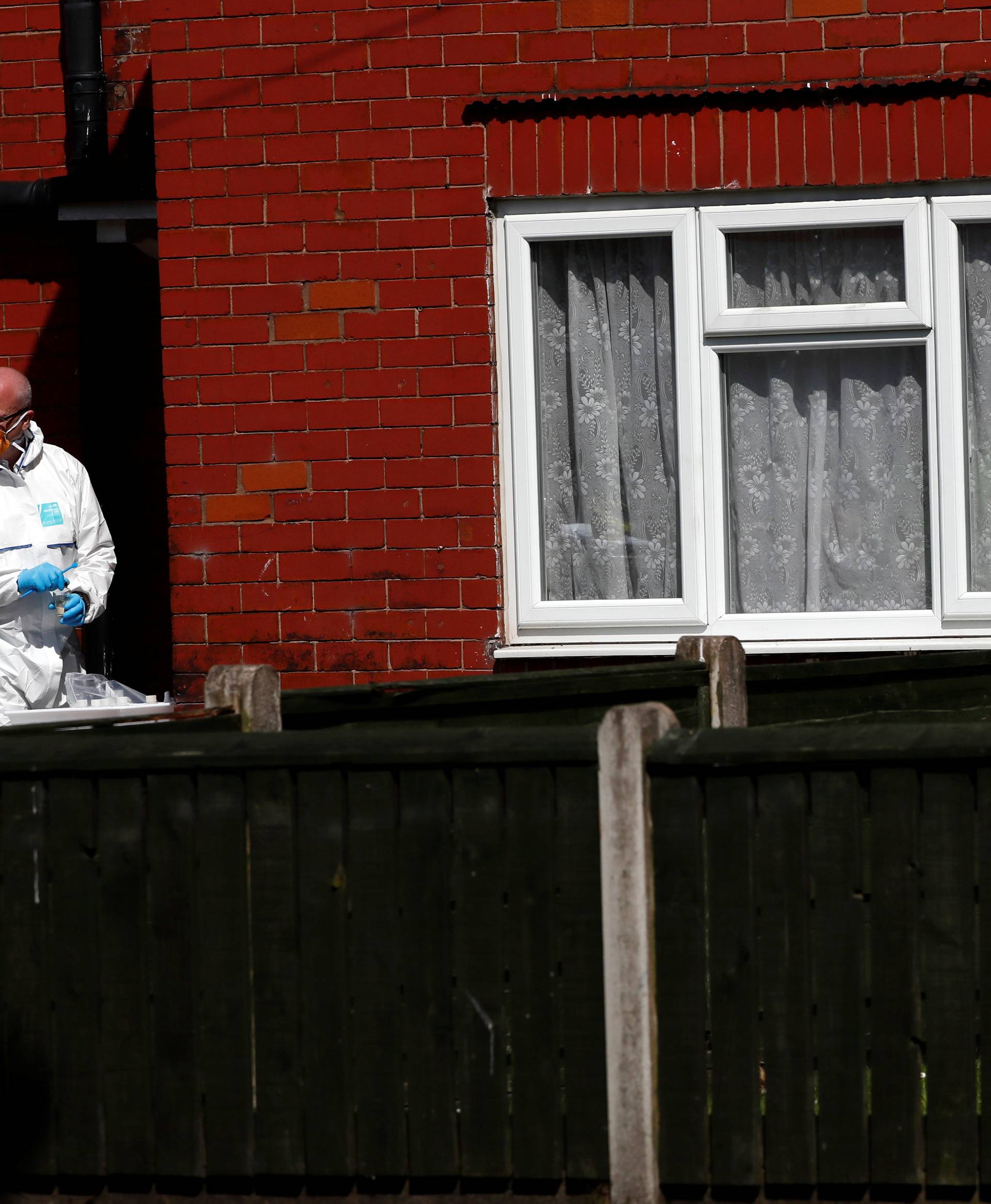 Police investigators work at residential property in south Manchester