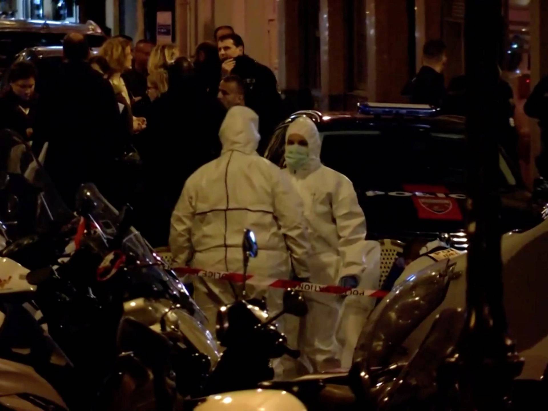Personnel are seen at the scene of a knife attack in Paris