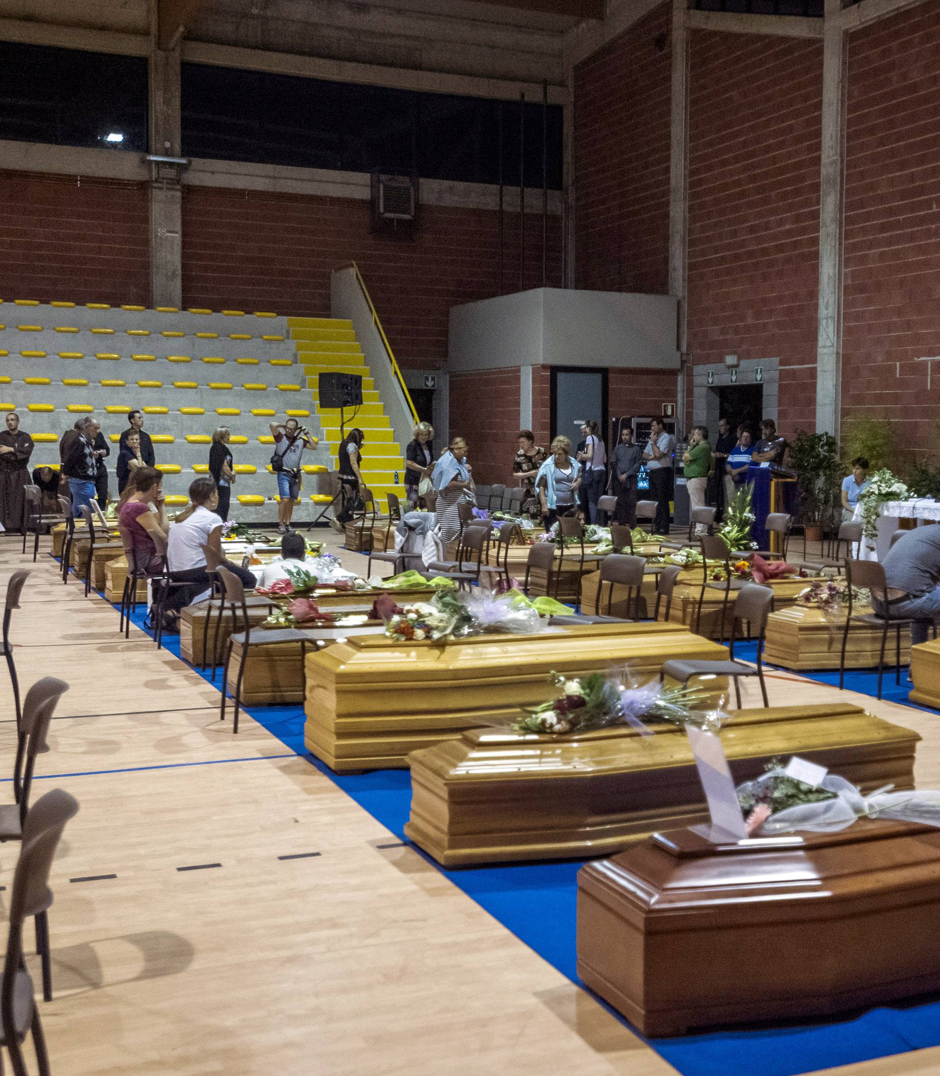 Coffins of some of the victims of the earthquake in central Italy are seen inside a gym in Ascoli Piceno