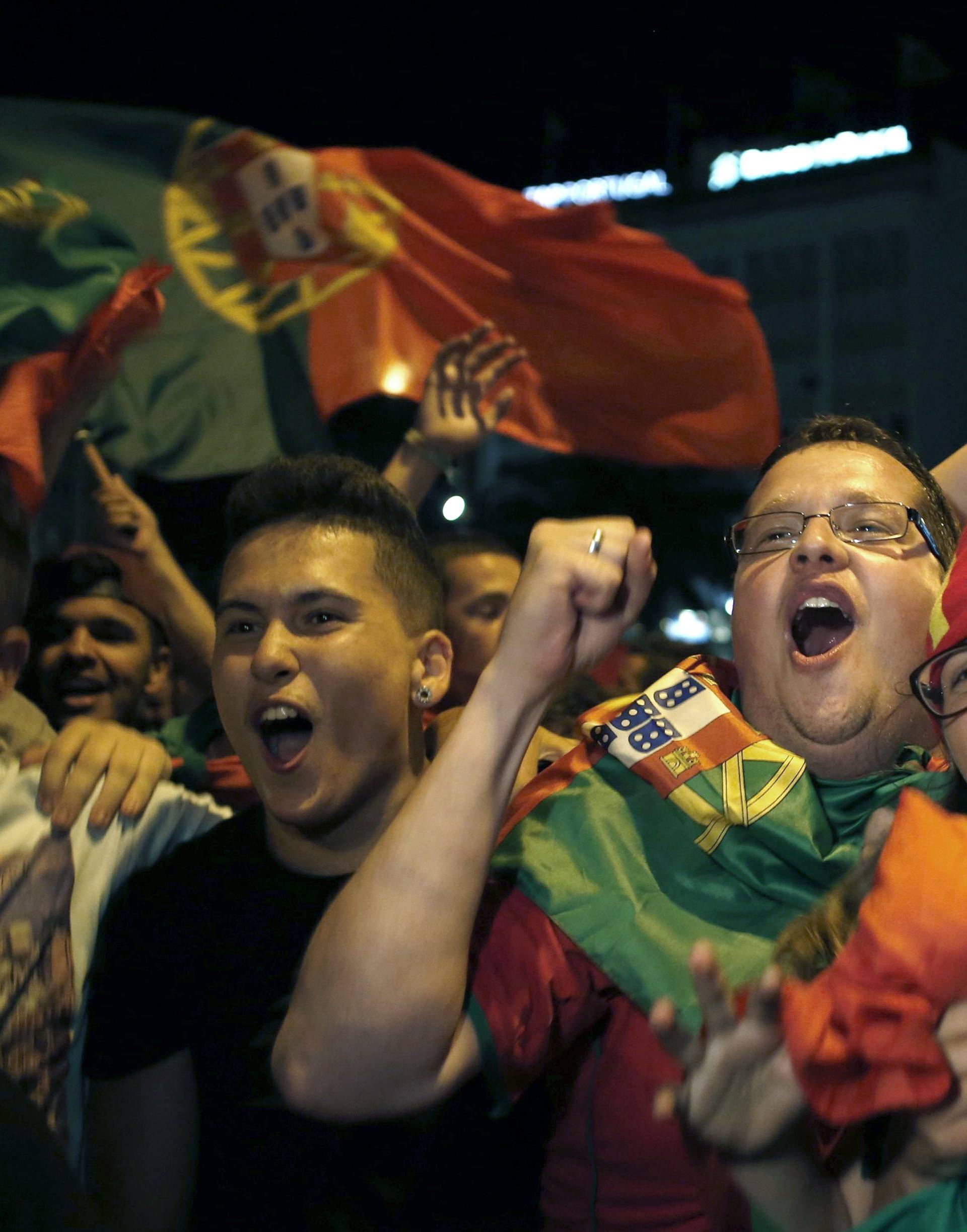 Fans of Portugal react after the Euro 2016 final between Portugal and France in Lisbon